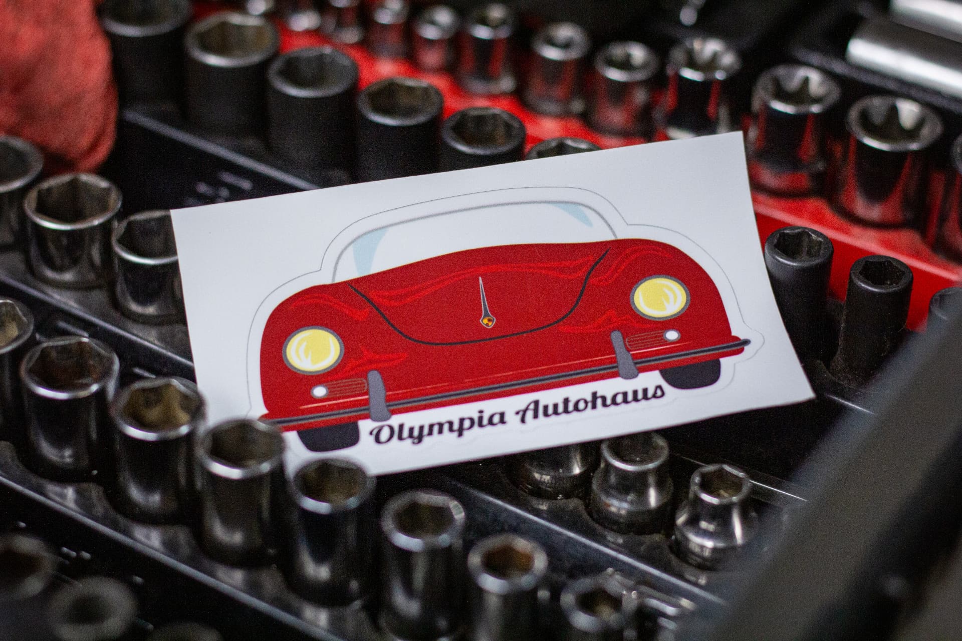 Olympia Autohaus brand sticker displayed with mechanic tools