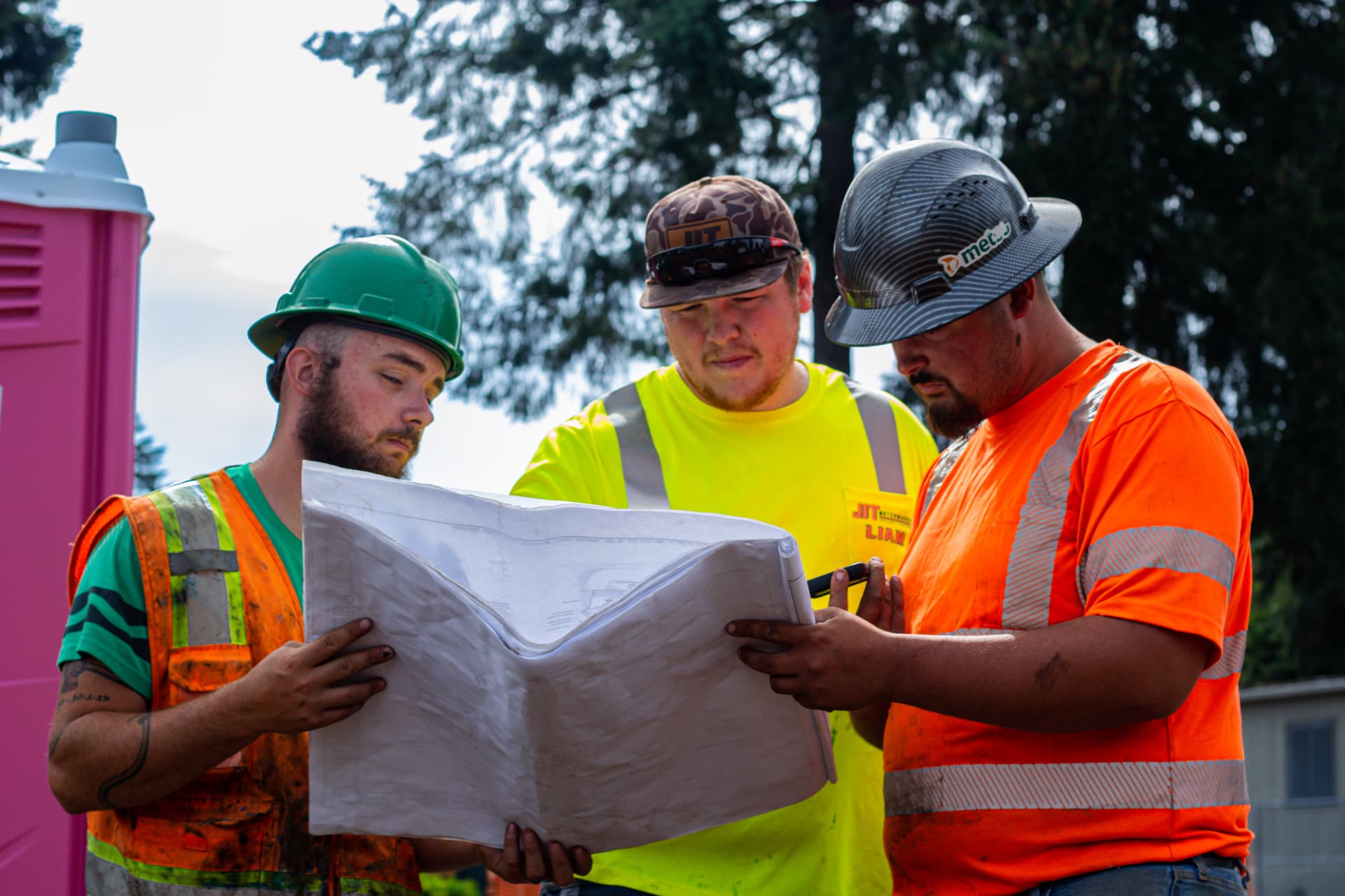 JIT Landscaping and Waterworks crew reviewing plans on site