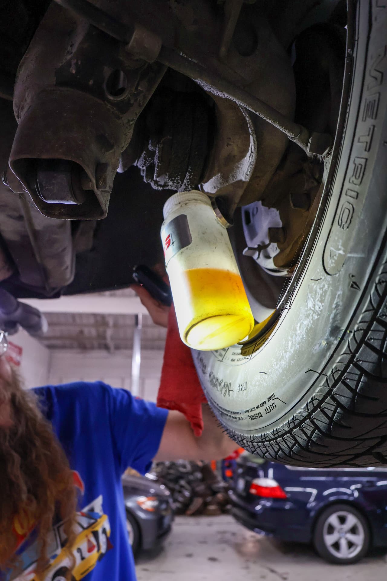 Olympia Autohaus technician servicing a vehicle brake